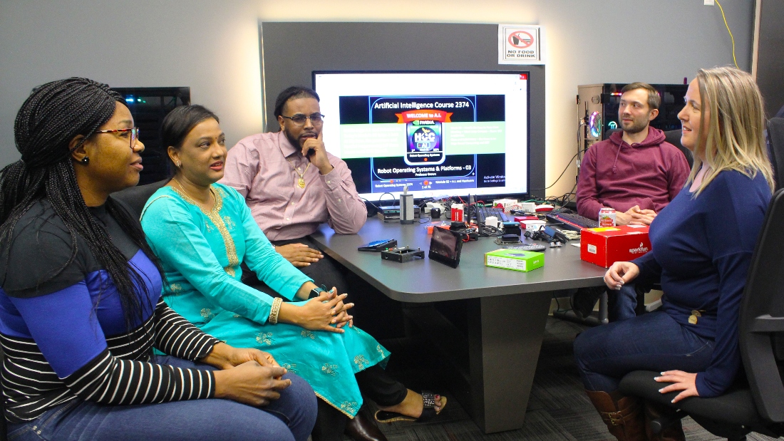 From left, Cordelia Omonkhegbe, Neethi Anand Gangidi, Denzel Wilson, Andrei Tcenev, and Dina-Marie Stager discuss their projects before an evening class. They will be the first to graduate from HCC’s artificial intelligence program in May.