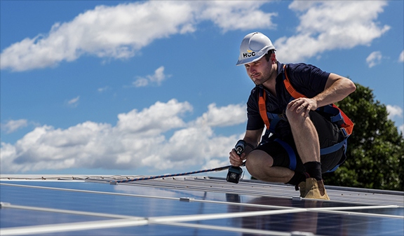 A worker installs a solar panel