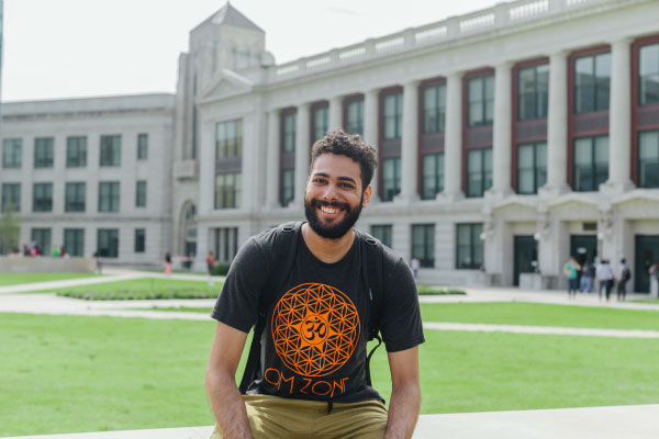 Male student standing infront of HCC Central building